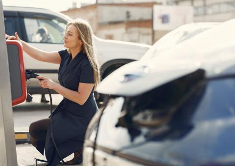 woman at ev charging station